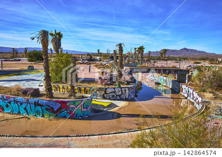 Abandoned Lake Dolores Water Park Graffiti and Palm Trees in California Desert Abandoned Lake Dolores Water Park Graffiti and Palm Trees in California Desert 142864574