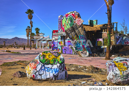 Abandoned Lake Dolores Water Park Graffiti Ruins and Palm Trees in California Desert Abandoned Lake Dolores Water Park Graffiti Ruins and Palm Trees in California Desert 142864575