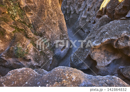 Rock Passage and Sunlit Trail in Rugged Mojave Desert Canyon Landscape Rock Passage and Sunlit Trail in Rugged Mojave Desert Canyon Landscape 142864832