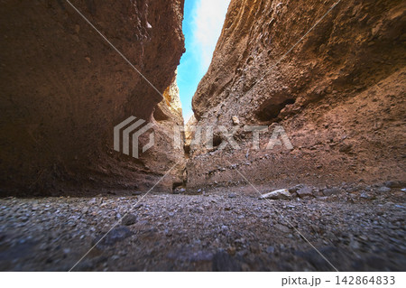 Slot Canyon Rock Walls and Sunlit Passage with Blue Sky Perspective Slot Canyon Rock Walls and Sunlit Passage with Blue Sky Perspective 142864833