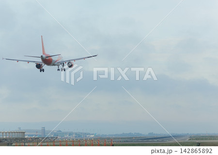 Airplane landing on a runway Airplane landing on a runway 142865892
