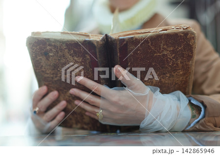 Person holding antique book 142865946