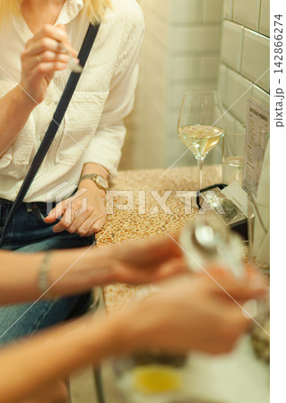 Woman dining at a cafe counter 142866274