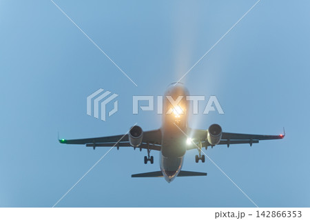 Airplane landing with lights on Airplane landing with lights on 142866353