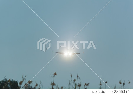 Airplane approaching with headlights on 142866354
