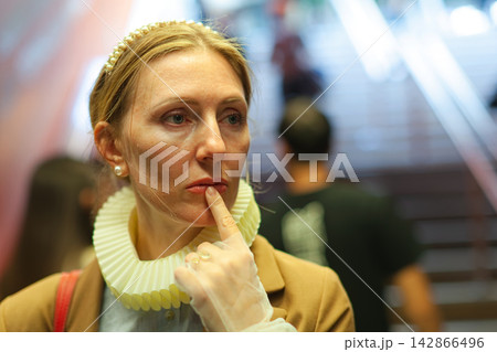 Woman in ruffled collar with contemplative expression Woman in ruffled collar with contemplative expression 142866496