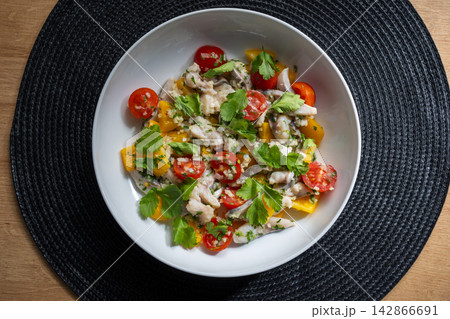 Ceviche in white bowl overhead with wooden table background Ceviche in white bowl overhead with wooden table background 142866691