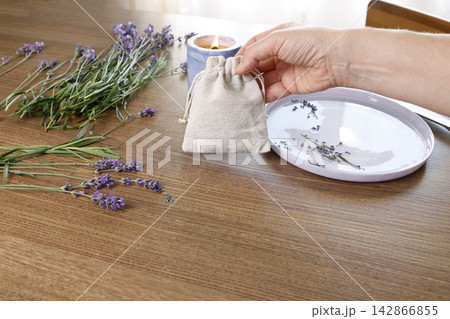 Minimalist cotton sachet mockup for organic lavender product branding. Sustainable linen pouch packaging on wooden table background near candle. Aesthetic aromatherapy merchandise design layout Minimalist cotton sachet mockup for organic lavender product branding. Sustainable linen pouch packaging on wooden table background near candle. Aesthetic aromatherapy merchandise design layout 142866855