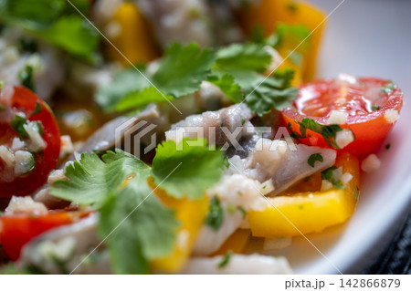Ceviche close view with yellow pepper cilantro leaf and fish Ceviche close view with yellow pepper cilantro leaf and fish 142866879