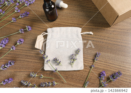 Handmade organic lavender spa cosmetic set with natural sachet bag on wood. Cozy home wellness gift box aromatherapy merchandise presentation backdrop. Minimalist rustic lifestyle branding mockup elem 142866942