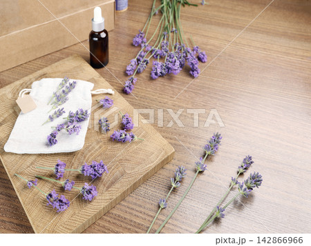 Organic lavender essential oil bottle and sachet mockup product shot. Commercial eco cosmetic ingredients and handmade spa beauty line backdrop. Natural aromatherapy wellness merchandise branding pres 142866966