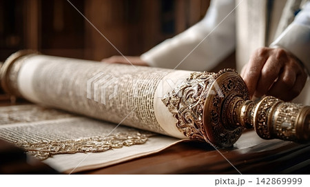 Rabbi's hands reading sacred torah scroll during religious ceremony 142869999