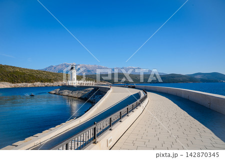 Lustica Lighthouse And Mountains Above The Blue Adriatic Lustica Lighthouse And Mountains Above The Blue Adriatic 142870345