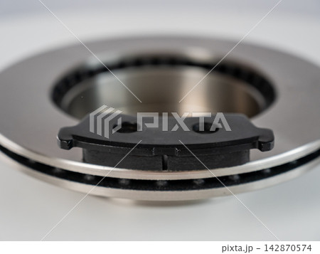 A close-up of new brake discs on a white background. A close-up of new brake discs on a white background. 142870574