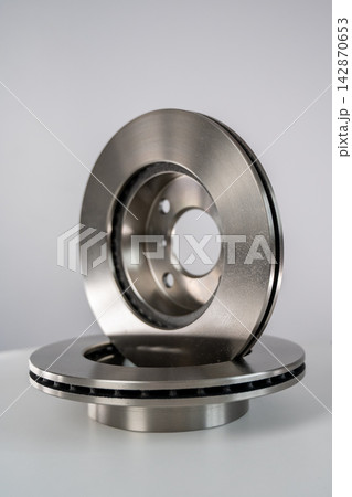 A close-up of new brake discs on a white background. 142870653
