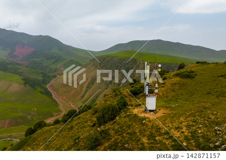 Communication Tower Overlooking Verdant Mountain Valley Communication Tower Overlooking Verdant Mountain Valley 142871157