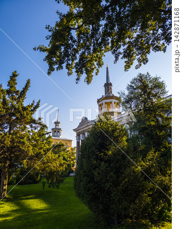 Classical Building with Ornate Spires and Greenery 142871168