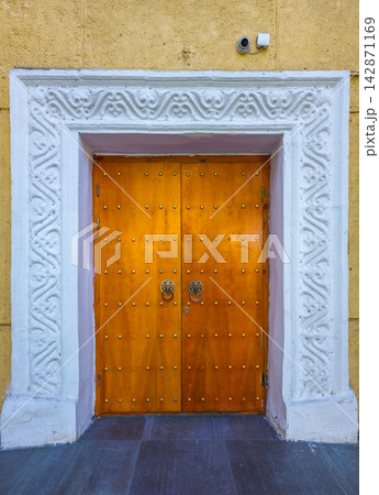 Ornate Wooden Double Doors with Lion Head Knockers 142871169