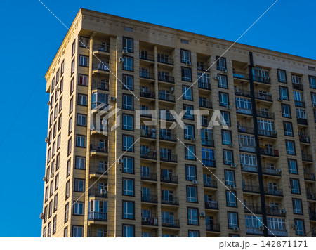 Modern Apartment Building with Balconies and Windows Modern Apartment Building with Balconies and Windows 142871171