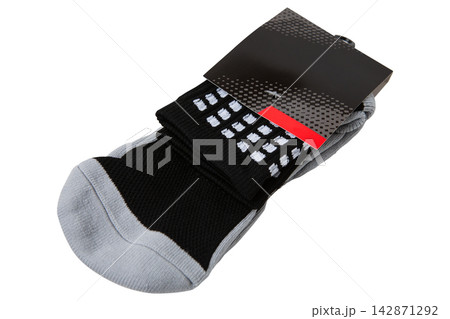 Pair of black and grey athletic socks in paper packaging isolated on white background Pair of black and grey athletic socks in paper packaging isolated on white background 142871292