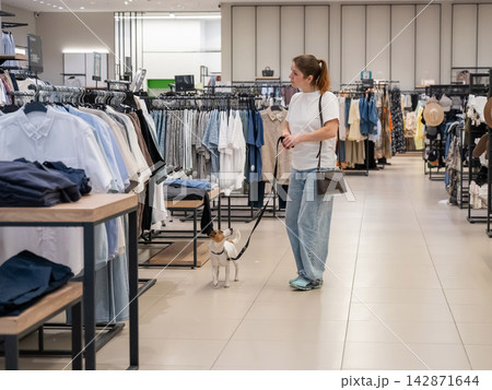 Caucasian woman in a shopping mall with a Jack Russell Terrier dog. Caucasian woman in a shopping mall with a Jack Russell Terrier dog. 142871644