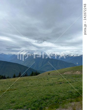 A beautiful view overlooking mountains on a cloudy day from Hurricane Ridge. 142872248