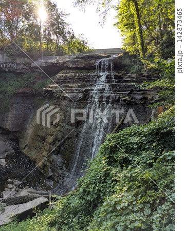 Sunlit waterfall cascading down a cliff in Cuyahoga Valley National Park 142873465