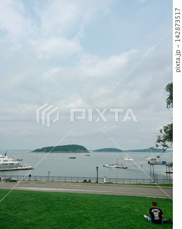 Cloudy waterfront view of boats and islands in scenic Bar Harbor, Maine coast Cloudy waterfront view of boats and islands in scenic Bar Harbor, Maine coast 142873517