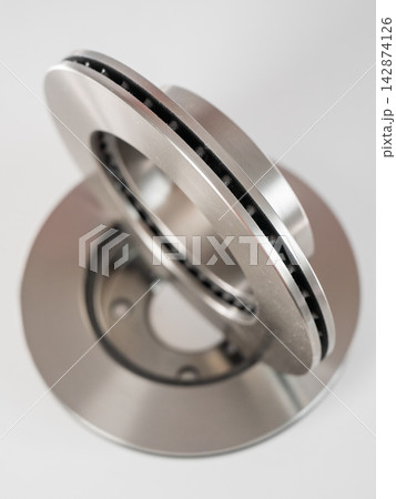 A close-up of new brake discs on a white background. A close-up of new brake discs on a white background. 142874126