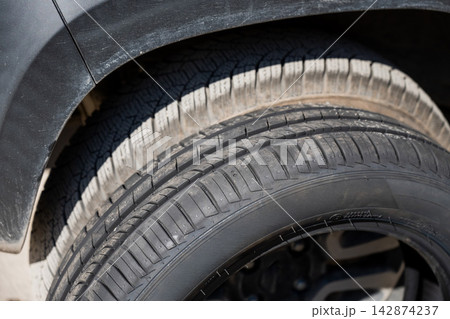 Changing car tires according to the season.  142874237