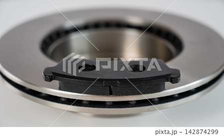 A close-up of new brake discs on a white background. A close-up of new brake discs on a white background. 142874299
