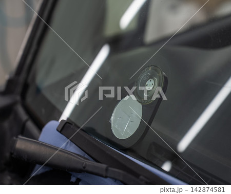 Repairing a chip on a car windshield.  142874581