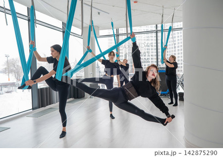Group yoga class on hammocks. Group yoga class on hammocks. 142875290