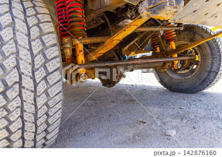 Old School Leaf Spring and double Coils Off-Road Vehicle Suspension and Knobby Tire Old School Leaf Spring and double Coils Off-Road Vehicle Suspension and Knobby Tire 142876160