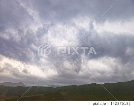 Dramatic Cloudy Sky Over Green Rolling Hills Landscape Dramatic Cloudy Sky Over Green Rolling Hills Landscape 142876182