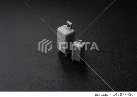 Two suitcases on a black background representing the concept of travel, emigration, or air travel Two suitcases on a black background representing the concept of travel, emigration, or air travel 142877456