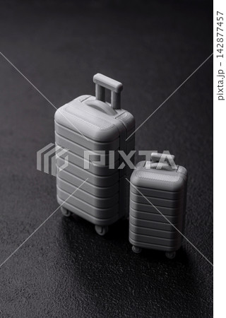 Two suitcases on a black background representing the concept of travel, emigration, or air travel 142877457