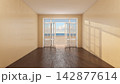 Empty Coastal Room with Open French Window, Beach View and Warm Sunlight 142877614