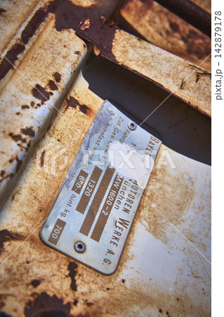 Close Up Rusted Abandoned Vehicle Tag and Weathered Metal Texture 142879178