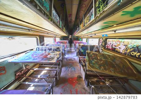 Abandoned Graffiti Covered Caltrain Passenger Car Interior with Broken Tables California 142879783