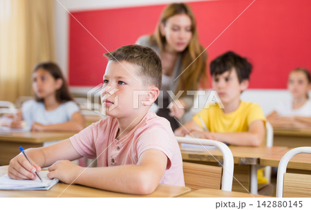 Schoolboy sitting in classroom during lesson in elementary school 142880145