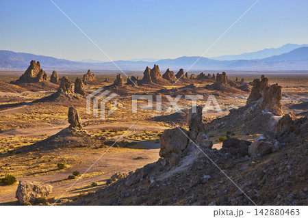 Trona Pinnacles Tufa Spires and Desert Landscape with Distant Mountains California Trona Pinnacles Tufa Spires and Desert Landscape with Distant Mountains California 142880463