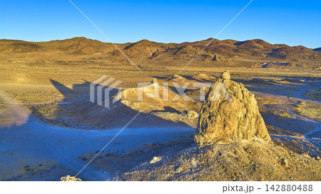 Aerial Trona Pinnacles Sunlit Desert Landscape and Mountain Ridges at Golden Hour 142880488