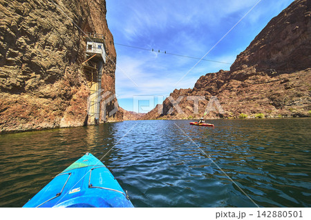 Kayak on Colorado River with Historic Gauging Station and Cable Tramway in Arizona Kayak on Colorado River with Historic Gauging Station and Cable Tramway in Arizona 142880501