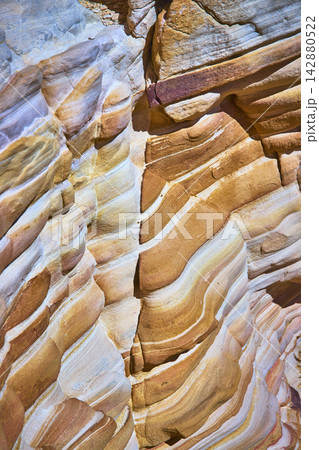 Layered Sandstone Rock Texture with Vibrant Desert Colors and Erosion Patterns Layered Sandstone Rock Texture with Vibrant Desert Colors and Erosion Patterns 142880522