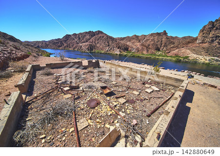 Abandoned Gauging Station Foundation Beside Colorado River in Rugged Desert Landscape 142880649