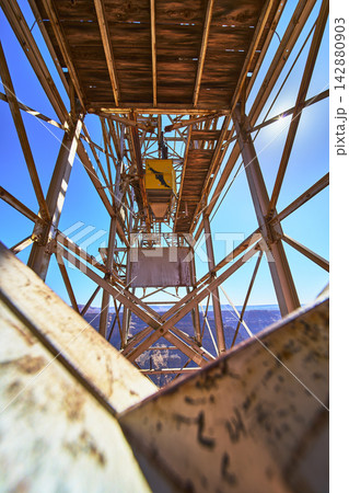 Abandoned Mine Structure with Weathered Metal and Grand Canyon Cliffs Perspective 142880903