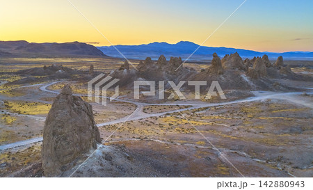 Aerial Trona Pinnacles California Desert Landscape with Tufa Spires and Distant Mountains Aerial Trona Pinnacles California Desert Landscape with Tufa Spires and Distant Mountains 142880943