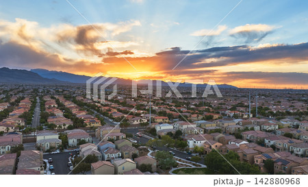 Aerial Las Vegas Neighborhood at Sunset with Mountain Views and Dramatic Sky 142880968