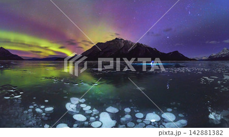 Panorama Frozen Lake Northern Lights and Ice Bubbles Under Winter Night Sky Panorama Frozen Lake Northern Lights and Ice Bubbles Under Winter Night Sky 142881382